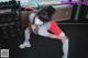 A woman wearing a face mask in a gym.