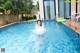 A woman in a swimming pool with an inflatable ring.